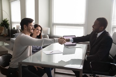 advisor shakes hands with clients